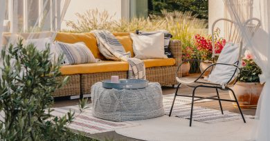 modern-outdoor-furniture-set-including-wicker-sofa-with-yellow-cushions-and-metal-chair