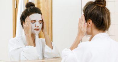 Woman in her bathroom putting a facial mask on - using different facial masks from the Facetory collection.