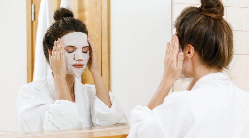 Woman in her bathroom putting a facial mask on - using different facial masks from the Facetory collection.