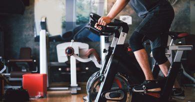Man working out at home using his stationary bike.