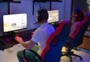 Couple playing computer games while sitting on a budget-friendly gaming chair.
