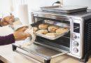 Woman baking cookies using a toaster oven - using air fryer to cook meals.