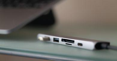 A multi-purpose USB hub adapter connected to a laptop device.